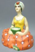 HENRI DELCOURT PORCELAIN INK WELL in the form of a seated woman with turban holding a bowl for the