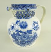 A GLAMORGAN EARTHENWARE PUZZLE JUG IN THE CHRYSANTHEMUM TRANSFER PATTERN of bellied form with loop