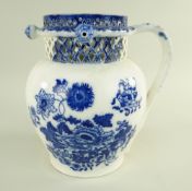 A GLAMORGAN EARTHENWARE PUZZLE JUG IN THE CHRYSANTHEMUM TRANSFER PATTERN of bellied form with loop