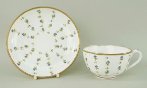 A NANTGARW PORCELAIN CUP & SAUCER decorated with scattered cornflower motifs within a solid gilt