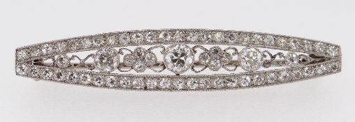 WHITE METAL ART DECO DIAMOND BAR BROOCH, the tapering boat shaped design encrusted with diamonds,
