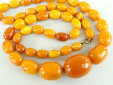 STRING OF AMBER BUTTERSCOTCH BEADS the oval graduated beads measuring 1.3cms long (smallest) to 3cms