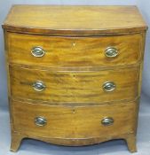 REGENCY CROSSBANDED MAHOGANY BOW FRONT CHEST of three drawers with oval backplates and swing handles