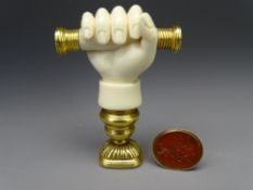 VICTORIAN DESK & FOB SEALS, the desk seal of carved ivory in the form of a hand gripping a baton,