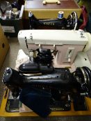 THREE VINTAGE SEWING MACHINES including a cased hand crank example by Singer, a 99K as the