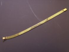 A 9CT GOLD BRACELET of seven narrow bands with clip fastener, 13.9grms