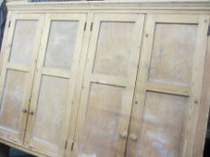 ANTIQUE STRIPPED PINE FOUR DOOR WALL CUPBOARD, open backed with shaped lower detail, 167cms H,