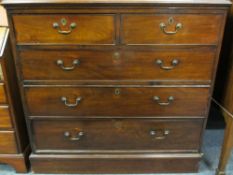 GEORGIAN MAHOGANY CHEST of two short over three long drawers, oak lined with brass pommel and swan