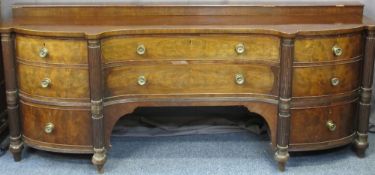 LARGE REGENCY MAHOGANY SERPENTINE FRONT SIDEBOARD having a closed box and shaped front top over an