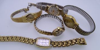 FIVE LADY'S WRISTWATCHES - a yellow metal circular dial wristwatch no. 432247 with incorporated bark