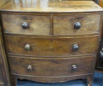 VICTORIAN MAHOGANY BOW FRONT CHEST of two short over two long drawers with turned wooden knobs on