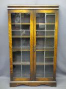 VINTAGE OAK LEADED GLASS TWO DOOR BOOKCASE with interior shelves on a plinth base, 134cms H, 80.5cms