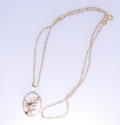 A 9CT GOLD OVAL LEAF PENDANT with two tiny sapphires and a nine carat gold flat curb chain, total