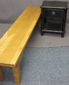 MODERN LONG OAK BENCH and a reproduction ebonized single drawer bedside table, 45cms H, 179.5cms