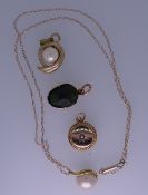 A NECK CHAIN & FOUR PENDANTS - a yellow metal oval link neck chain with yellow metal mounted pearl