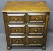NEAT CONTINENTAL OAK CHEST of two short over two long drawers with reeded front detail on bun