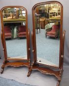 REPRODUCTION MAHOGANY CHEVAL MIRRORS, a pair, arched top frames and bevel edged mirrors on shaped