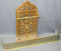 VICTORIAN CAST IRON STICK STAND and a brass fender, the stand with pierced floral detail, brass