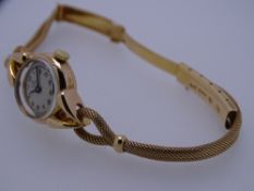 LADY'S 18CT GOLD OMEGA CIRCULAR DIAL WRISTWATCH with eighteen carat gold rope twist twin strand