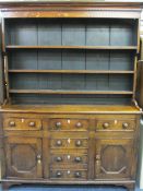 NORTH WALES ANGLESEY OAK DRESSER, CIRCA 1830, the wide boarded back three shelf rack with shaped