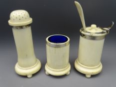 LATE 19TH CENTURY IVORY & WHITE METAL MOUNTED THREE PIECE CONDIMENT SET, cylindrical form on ball