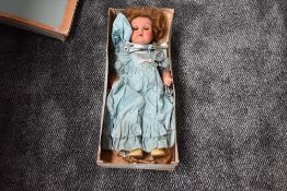 A Unica (belguim) composition doll having sleep eyes, open mouth with two teeth showing and
