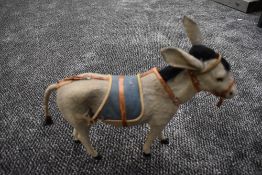 A mid 20th century clockwork plush Donkey having mechanical head with key, height 12 inches and