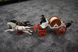A vintage cast metal model of a Horse Drawn Fire Hose Tender, made in the USA for a UK collector