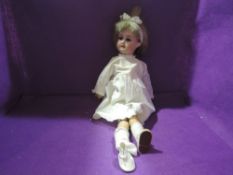 An early 20th century Armand Marseille bisque headed doll having sleep eyes, open mouth with four