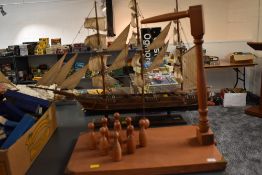 A House of Marbles Bar Skittles game, having nine skittles with string attached