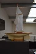 A large painted wooden radio controlled model sail boat on stand, having Acoms and Hitec control