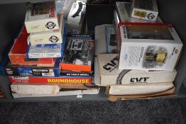 A shelf of HO and similar scale plastic accessories and kits including Atlas Roundhouse 709, Walther