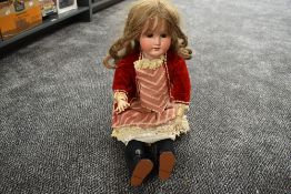 An early 20th century Heubach Koppelsdorf bisque headed doll having sleep eyes, open mouth with four