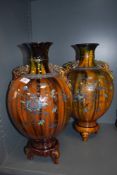 A pair of oriental possibly Japanese mantle vase or urns with three footed base and character seal