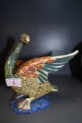 An early ceramic continental figure of a goose or swan possibly Majollica signed 23 to base (