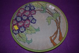 A large Art Deco styled charger plate by Charlotte Rhead depicting tree in bloom signed and