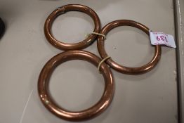 A set of three copper bull rings.