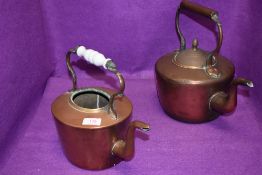 Two antique copper stove kettles having brass fitments