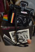 A Polaroid Super Colour Swinger II camera in original box