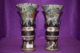An impressive pair of Chinese export mantle vases in hard paste having extensive detailing of