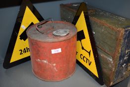 A military ammunition case, a petrol can and two Cctv signs