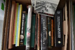 An assortment of books amongst which are of local interest, such as lake district, text and