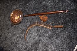 A vintage scythe having wooden handle, including hand guard and birch protective guard fitted to the