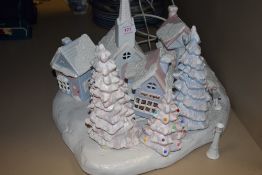 A light up Christmas decoration of a ceramic snow covered village
