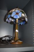 A modern tiffany styled leaded light with brass effect base