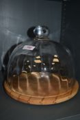 A lidded cheese dome with beech wood base by Dartington
