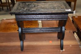An Eastern style stool, heavy carving throughout, width approx. 41cm