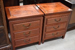A pair of Indonesian hardwood three drawer bedside chests , each approx. 46cm wide