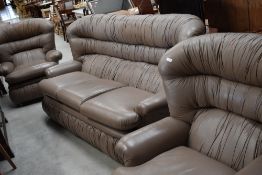 A vintage light brown leather three seater settee and two chairs