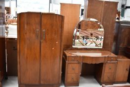 A 1930s walnut three piece bedroom suite comprising small robe, dressing table and one bedside